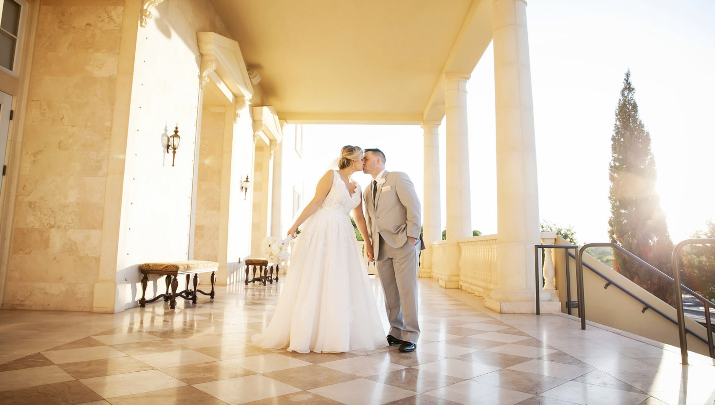 Couple on the balcony of The Regent at golden hour